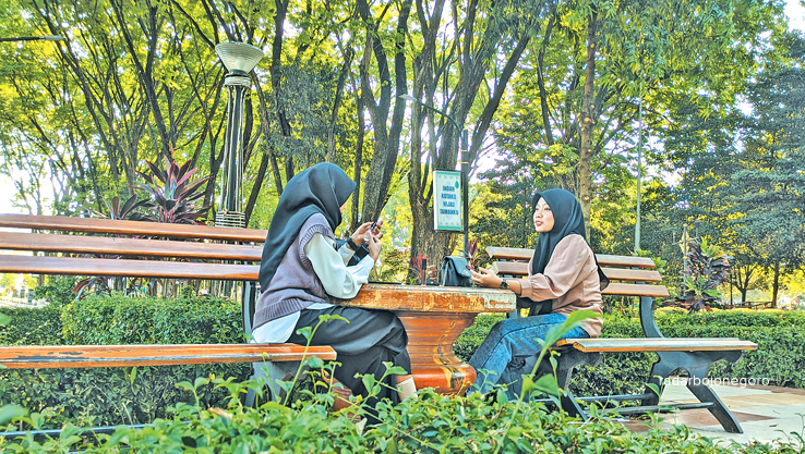 BERTEDUH: Kawasan taman di Alun-alun Bojonegoro masih dipadati warga berteduh kemarin (31/7). Pepohonan yang rindang jadi jujugan di tengah teriknya cuaca di musim kemarau. (DHANI WAHYU ALFIANSYAH/RDR