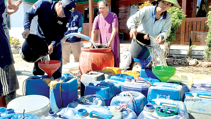 KEKERINGAN: Warga Japangrejo tampak antre bantuan air bersih, beberapa tangki berjejer menunggu giliran pengisian. (LUKMAN HAKIM/RDR.BLORA)
