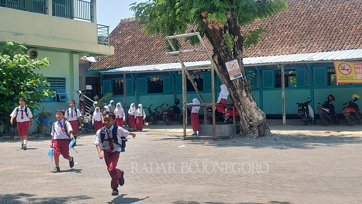 RIANG: Siswa-siswi di salah satu SD turut Kecamatan Cepu tampak berlari dengan riang saat bel pulang sekolah telah berbunyi.(LUKMAN HAKIM/RDR.BJN)