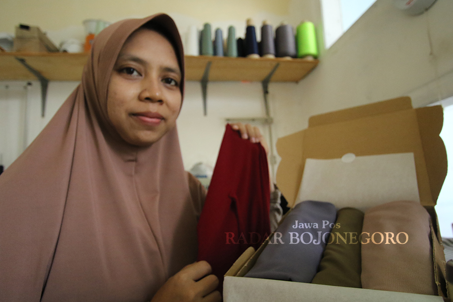 PESANAN: Nurlali menunjukkan hampers hijab pesanan salah satu konsumennya. (ANJAR DWI PRADIPTA/RADAR LAMONGAN)
