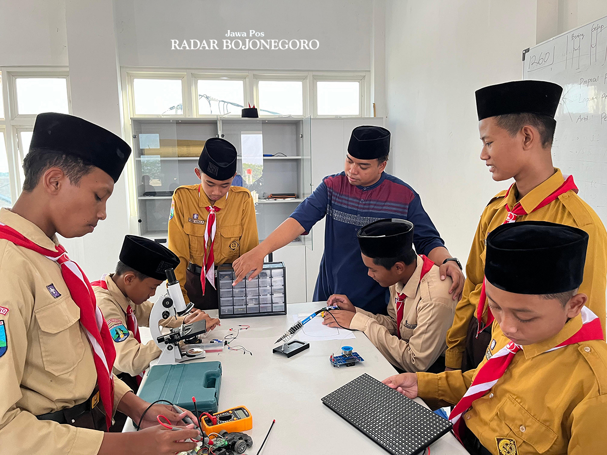 JUARA NASIONAL: Denny Zul Aji Soebrata Pembina Ekstrakurikuler Robotik SMP Plus Izzatul Ummah sedang praktik bersama Tim SH Torm Robotik (ISTIMEWA/RADAR BOJONEGORO)