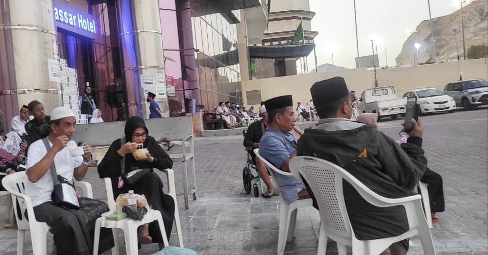 Para jemaah haji asal Indonesia sedang santai menikmati sarapan di pasar kaget usai salat subuh.