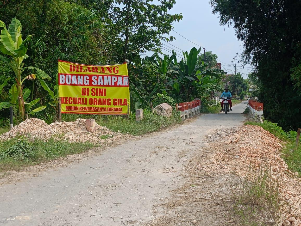 Banner peringatan buang sampah dari warga yang dipasang kawasan jembatan Desa Sumber, Kecamatan Kradenan, Blora.