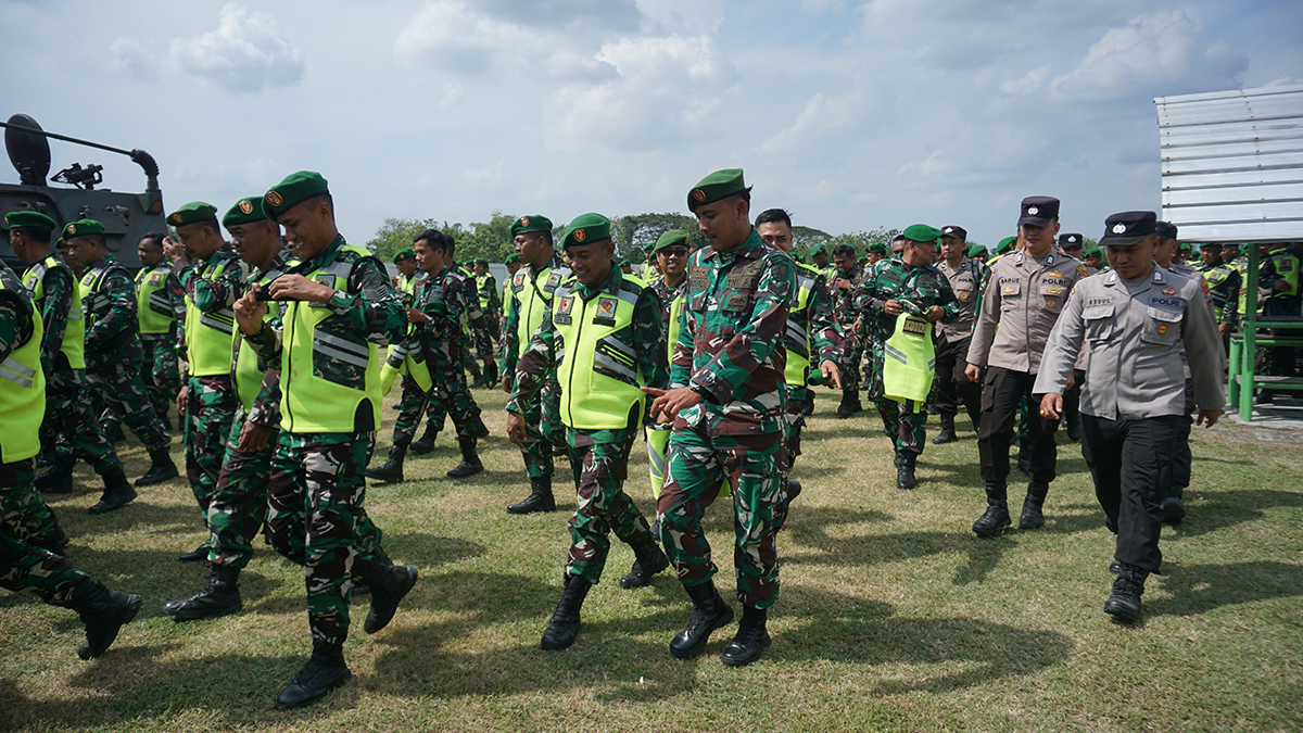 Pasukan Kodim 0813 dan Polres Bojonegoro bubar barisan setelah penjagaan kedatangan Presiden Prabowo Subianto dinyatakan selesai.  (YUAN EDO/RADAR BOJONEGORO)