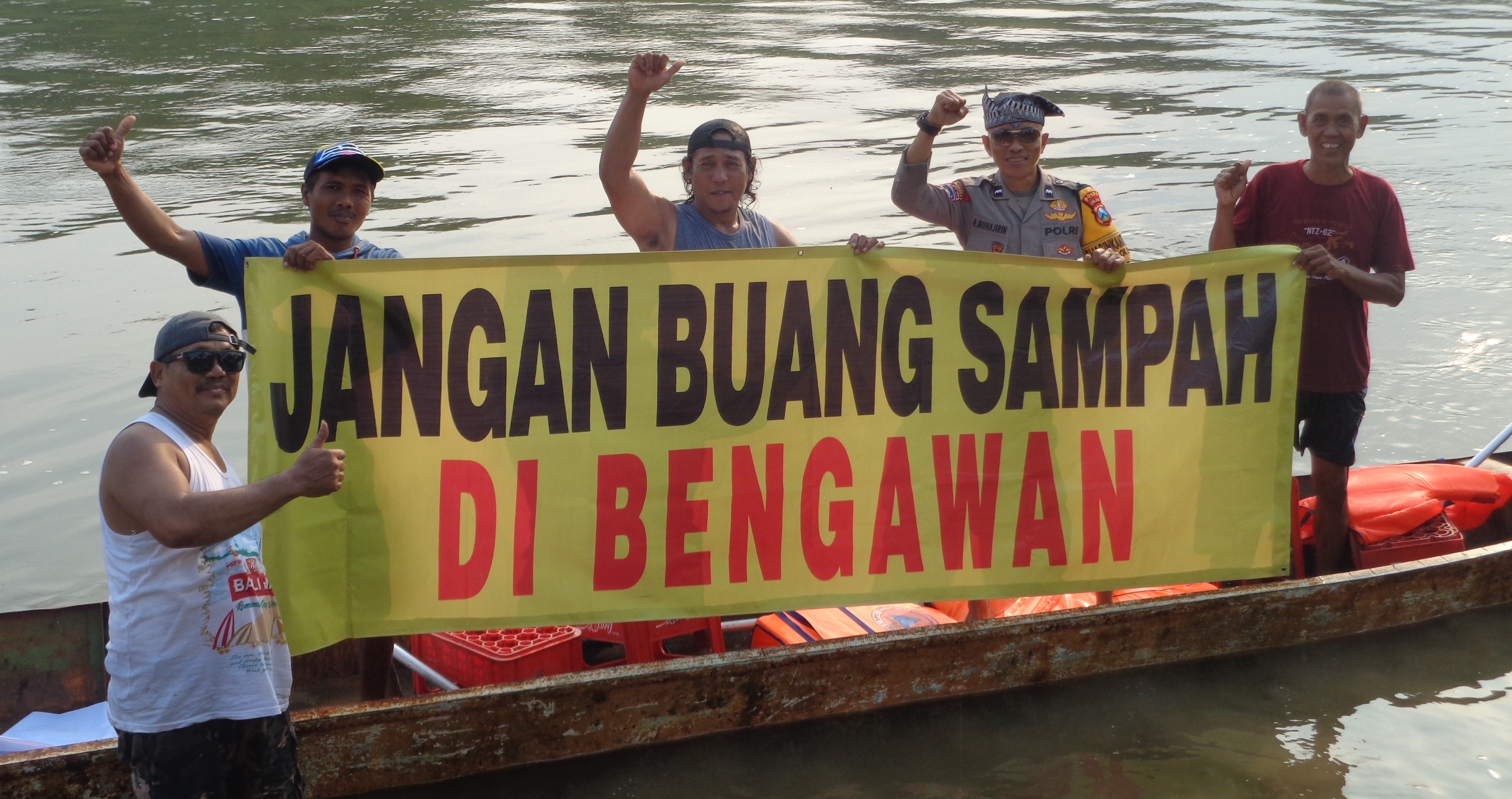 KAMPANYE LINGKUNGAN: Warga bentangkan poster berisi Jangan buang sampah di Bengawan Solo
