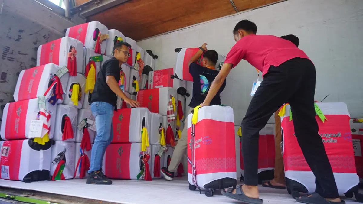 KOPER HAJI: Petugas mengangkut koper haji pada musim lalu, Kemenhaj Pastikan tahun ini tak ada haji furoda. (YUAN EDO/RADAR BOJONEGORO)