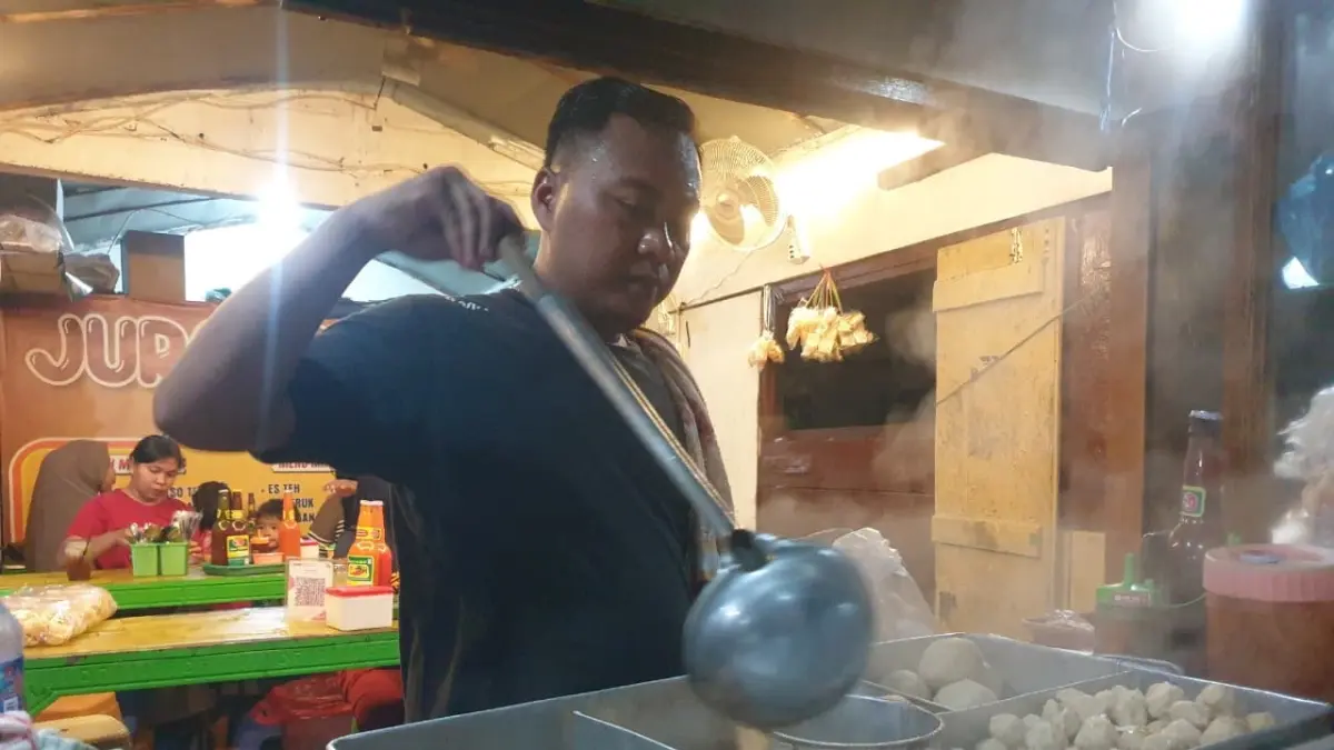 BERTAHAN : Salah satu pedagang bakso di Bojonegoro. Harga bahan baku makanan dan minuman saat ini naik. (HAKAM ALGHIVARI/RADAR BOJONEGORO)