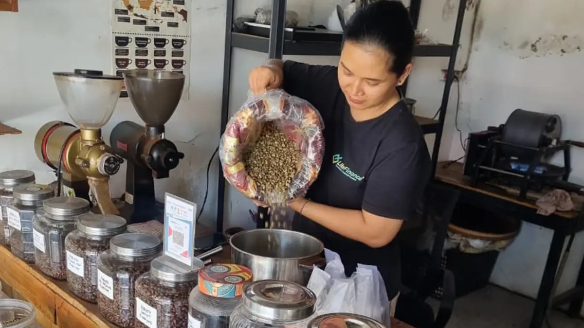 BIJI KOPI PILIHAN: Harya Susiana sedang memilah biji kopi pilihan di Toko Kopi Djadoel. (DEWI SAFITRI/RADAR BOJONEGORO)