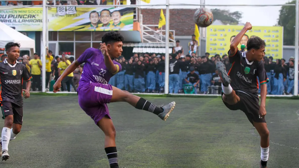 SENGIT: Pemain SMA Taruna Dra Zulaeha (kostum ungu) melepaskan tendangan yang diblok penggawa SMAN 1 Grati. SMAN Taruna menang dengan skor akhir 2-1. Foto kanan, SMKN 1 Grati melaju ke babak delapan besar setelah mengalahkan SMKN 1 Nguling dengan skor 5-4. (MUKHAMMAD ZUBAIDILLAH/RADAR BROMO)
