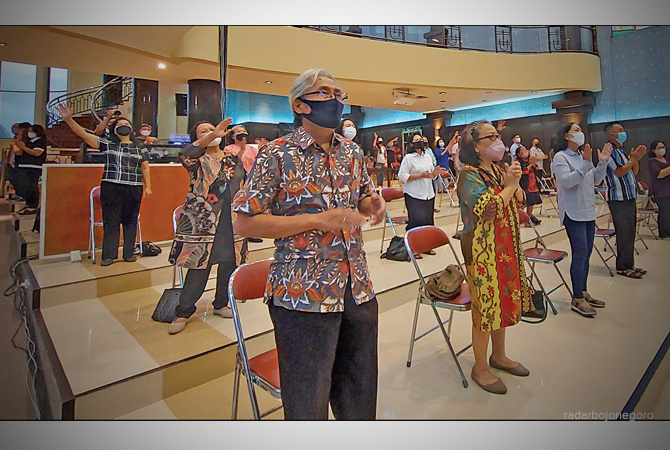 BERDOA: Semua jemaat berdiri melambaikan tangan melantunkan puji-pujian saat ibadah Kenaikan Isa Almasih di Gereja Bethany kemarin sore. (LUKMAN HAKIM/RDR.BLORA)