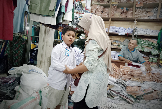 SAMBUT SEKOLAH: Aktivitas jual beli seragam di stan-stan Pasar Kota Bojonegoro. Permintaan ramai sejak libur semester lalu. (IRVAN RAMADHON/RDR.BJN)