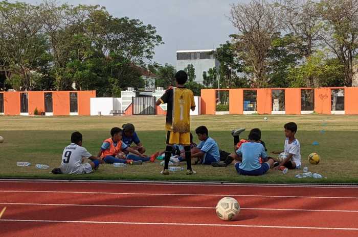 Sejumlah anak sedang beristirahat di sela latihan sepakbola di Lapangan Sidodadi Senin (3/7).