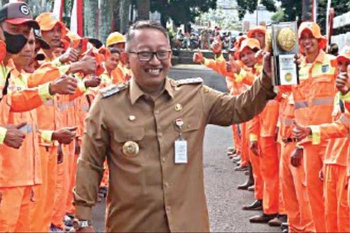 Pj Wali Kota Salatiga Sinoeng N Racmadi bersama para penyapu jalan menunjukkan piala Adipura.