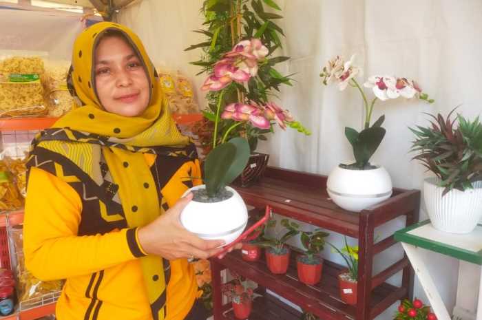 Purwaningsih pelaku usaha UMKM menunjukkan produk bunga buatannya di stan UMKM Kecamatan Guntur di Demak Expo 2023.