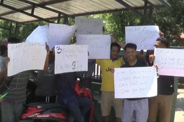 Sejumlah warga Desa Sendang Sikucing membawa poster bentuk protes pembangunan desa yang lamban.