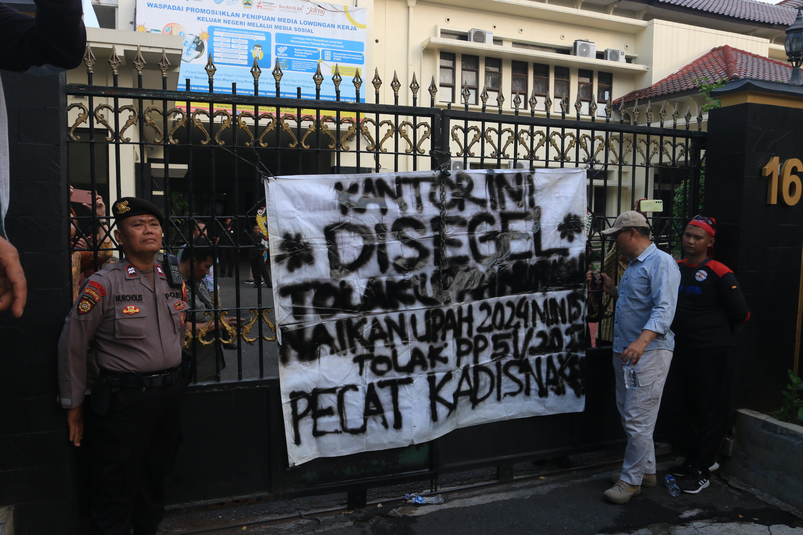 Para buruh menyegel Kantor Disnakertrans Jateng dengan rantai.