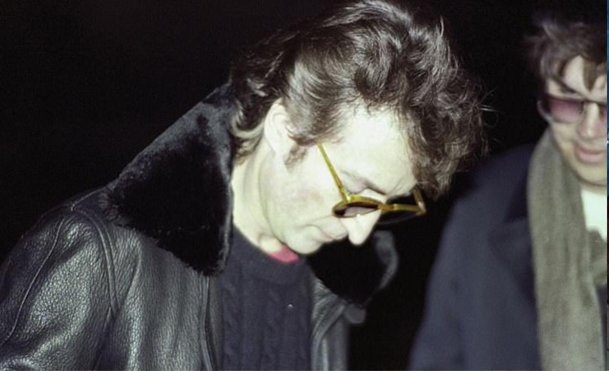 John Lennon is photographed for the last time signing a record album for his killer