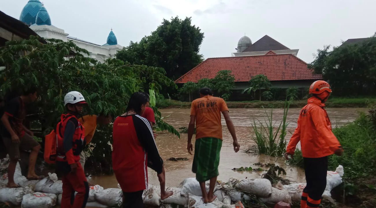 Sejumlah warga tamoak gotong royong menanggul Kali Waridin agar debit airnya tidak meluap ke permukiman Rabu (17/1). DEVI KHOFIFATUR RIZQI/ JAWA POS RADAR SEMARANG