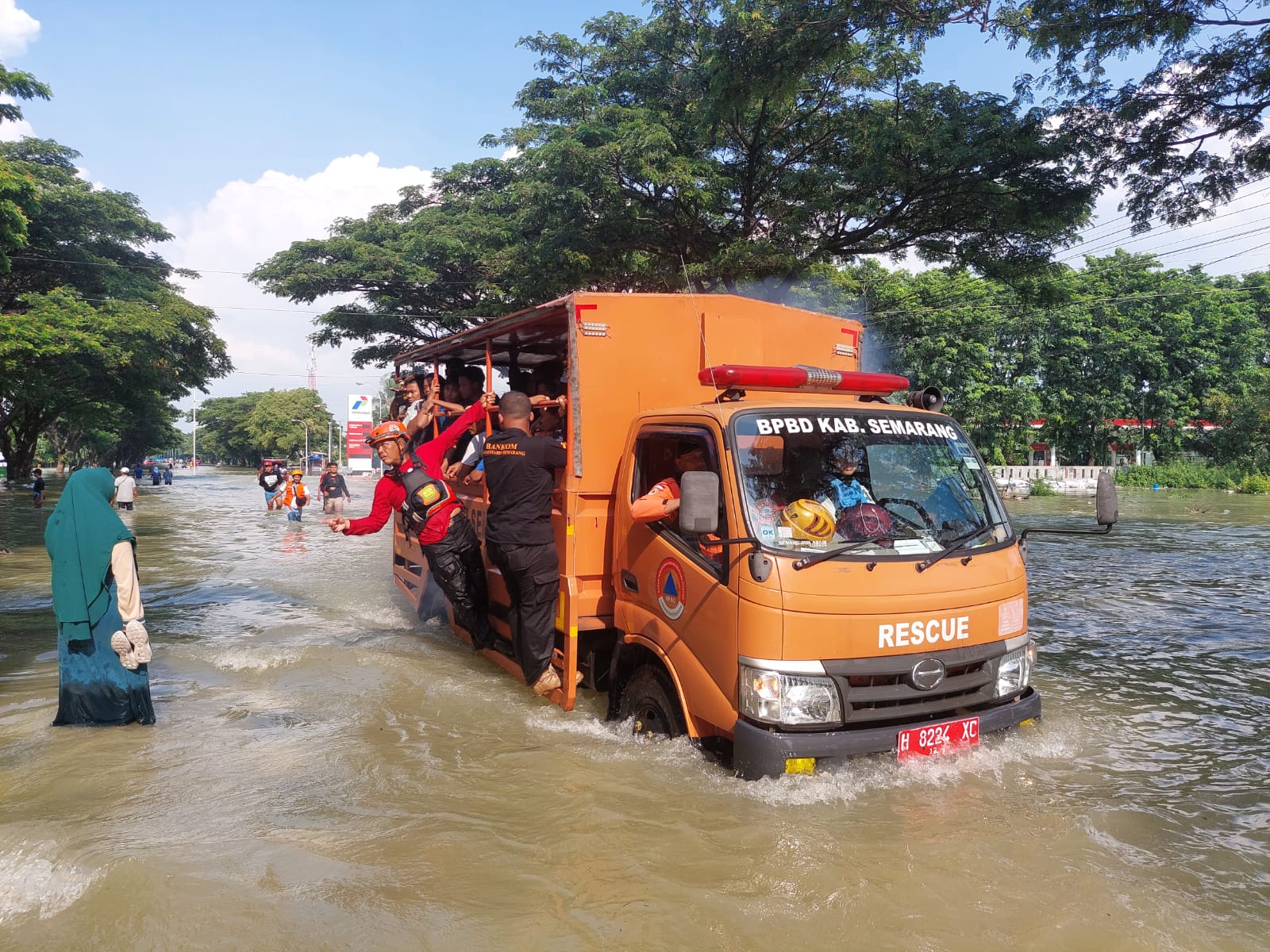 Truk tronton nekat lewat jalan yang kebanjiran setelah terjebak banjir. (Wahibpribadi)