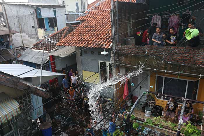 Prosesi perang air saat Gebyuran Bustaman di Kampung Bustaman RT 4 - 5 RW 3, Kelurahan Purwodinatan, Semarang Tengah, Minggu (3/3).NUR CHAMIM/JAWA POS RADAR SEMARANG