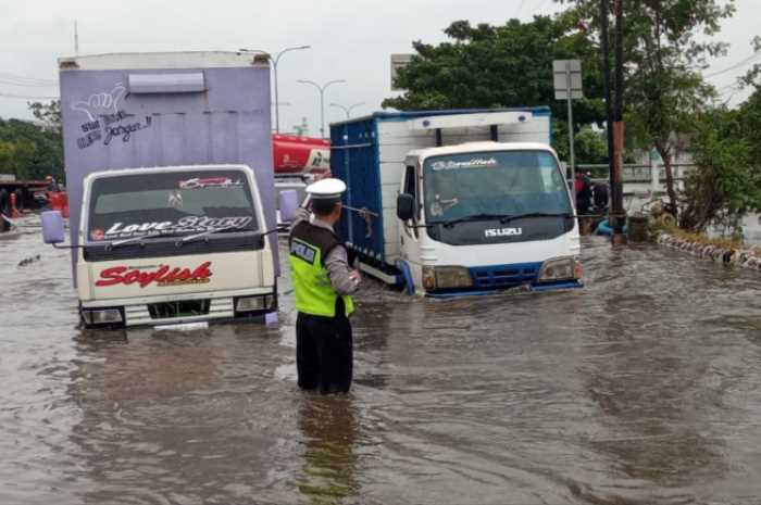 Jalan sepanjang Kaligawe Raya tepatnya Exit Tol Kaligawe hingga depan Rumah Sakit Islam (RSI) Sultan Agung Semarang terendam banjir, Rabu (13/3/2024). (M Hariyanto/Jawa Pos Radar Semarang)