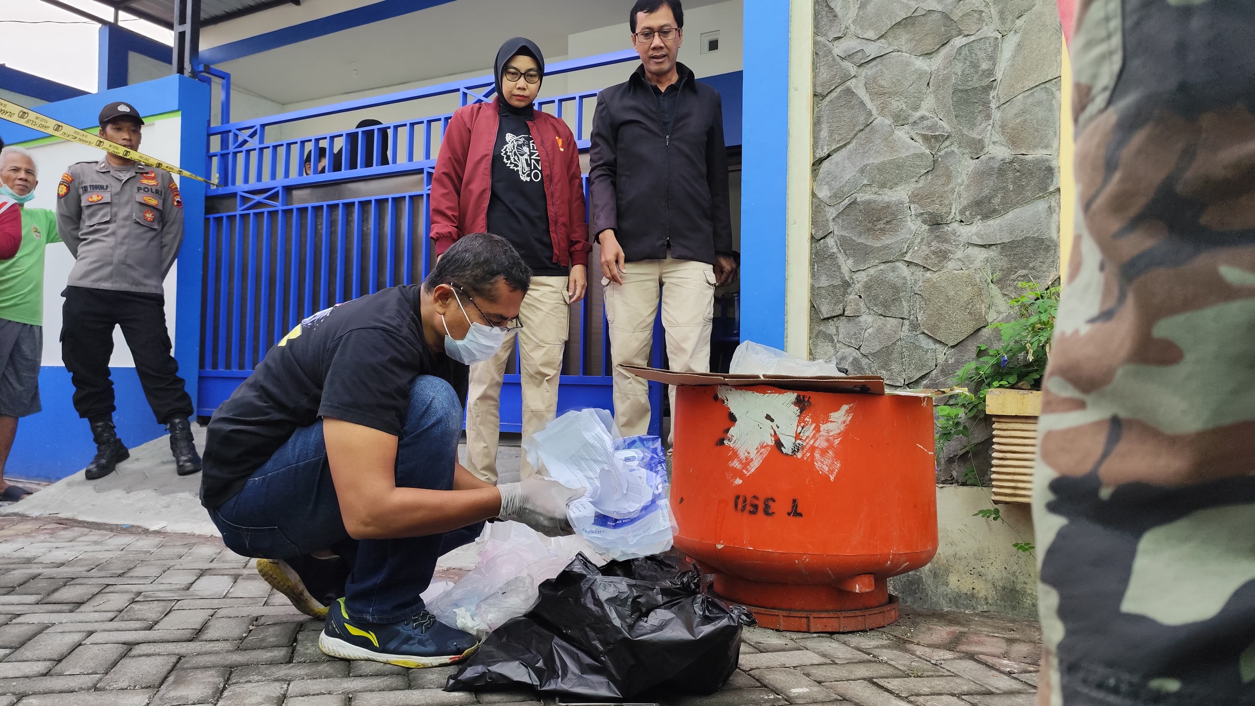Polisi melakukan olah TKP penemuan mayat bayi dalam bak sampah di Tembalang Semarang. (M Hariyanto/Jawa Pos Radar Semarang)