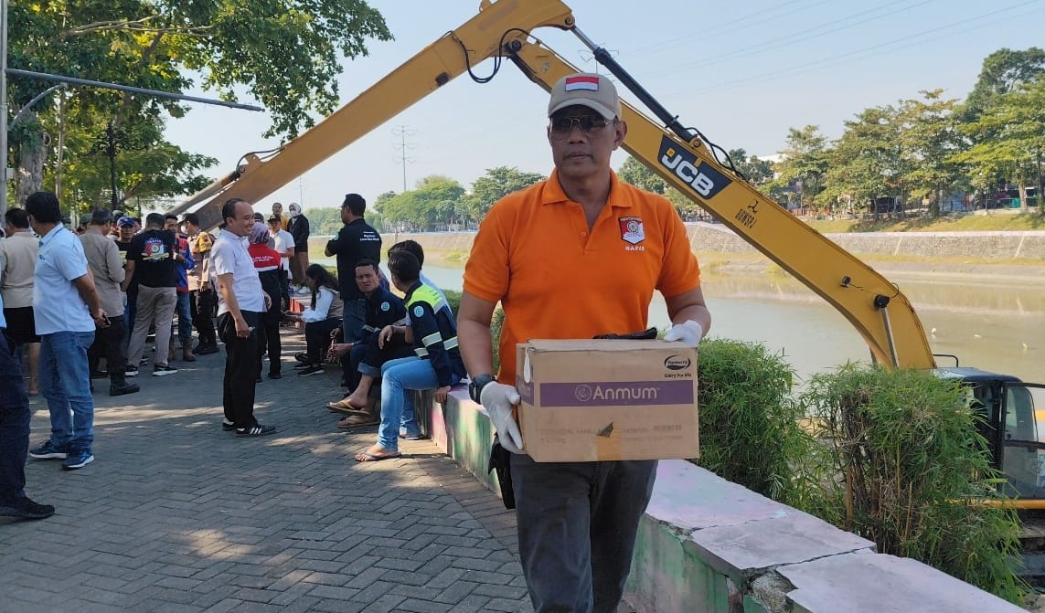 Warga berkerumun melihat Tim Inafis Polrestabes Semarang melakukan olah TKP Temuan Orok, di sungai BKB, Rabu (14/8/2024). (M Hariyanto/Jawa Pos Radar Semarang)