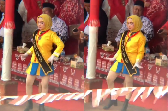 Gadis berkostum mayoret yang mengenakan jilbab viral lantaran memakai bawahan rok pendek.