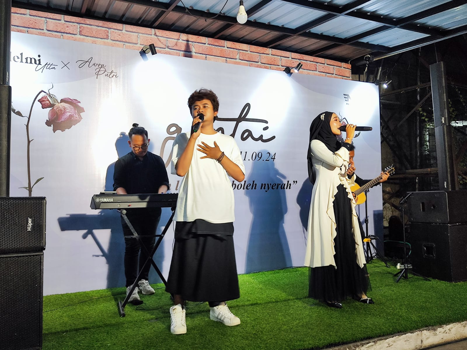 Penyanyi dari ENPI Records, Helmi Utta (kiri) dan Awra Putri (kanan) membawakan lagu Gontai di hadapan para penonton.