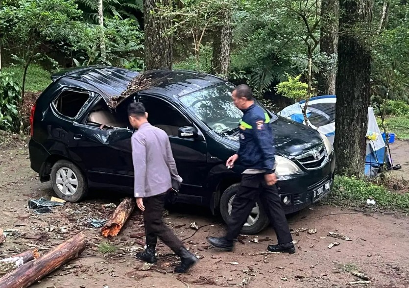 Pohon tumbang menimpa sebuah mobil dan tenda pengunjung New Sekipan Tawangmangu Karanganyar pada Jumat (4/4/2025).