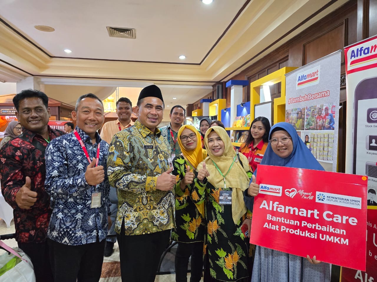 Corporate Communication Manager Alfamart, Budi Santoso (batik biru) bersama Wakil Gubernur Jateng  Taj Yasin memberikan bantuan kepada pelaku UMKM di sela peluncuran program Kumitra Kamis (20/11/2025)