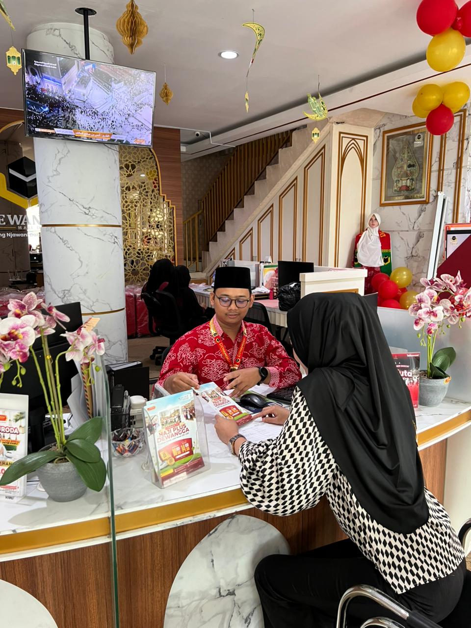 Salah satu calon jemaah umrah berdiskusi tentang keberangkatan umrah di Biro Travel Umrah dan Haji Dewangga di Kota Semarang.
