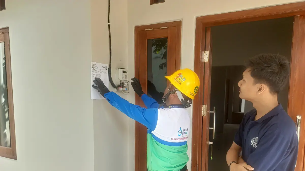 Petugas melakukan proses penambahan daya di rumah Alfonso, warga Banyumanik
