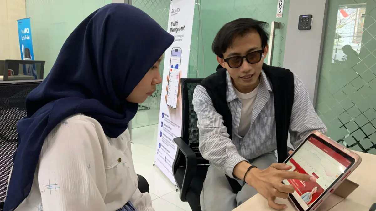 Seorang Gen Z sedang belajar dan melihat pergerakan saham.