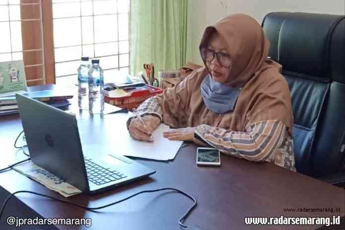 Rita Sari Pujiastuti, salah satu peserta pelatihan asal Banda Aceh terlihat serius mendengarkan pelatihan penulisan populer SMPN 2 Salatiga bersama Jawa Pos Radar Semarang melalui daring. (Dhinar Sasongko/Jawa Pos Radar Semarang)