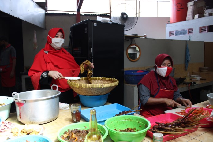 Lilik Alfiah (kiri) generasi ketiga pemilik Warung Makan Sate Mbak Tun Ungaran sedang meracik gule. (Maria Novena/Jawa Pos Radar Semarang)