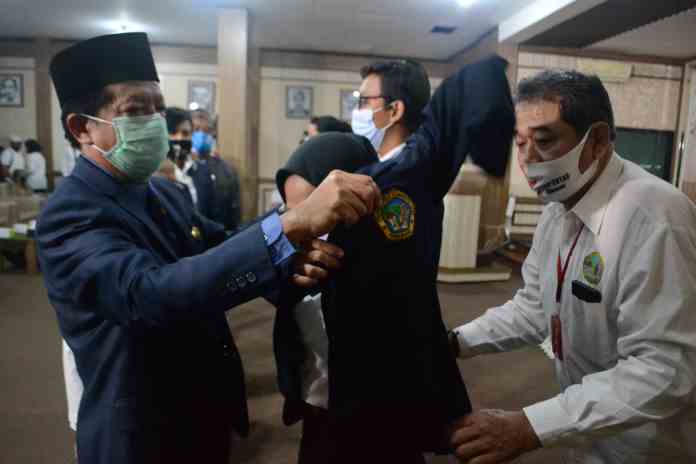 TERIMA MAHASISWA BARU : Rektor Untag Semarang Prof Dr Suparno MSI ketika memakaikan jaket almamater kepada mahasiswa baru di gedung Graha Kebangsaan, Sabtu (24/10). (M NUR WAHID/JAWA POS RADAR SEMARANG)