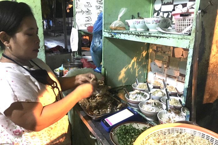 Tutik karyawan soto Pak Joko tengah menyiapkan hidangan untuk pelanggan. (Alvi Nur Janah/Jawa Pos Radar Semarang)