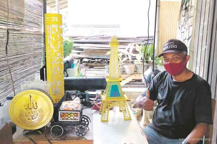 Anjar Setiawan membuat kerajinan lampu hias menggunakan paralon. Dia melakukannya sejak 2018. (RIRI RAHAYU/JAWA POS RADAR SEMARANG)