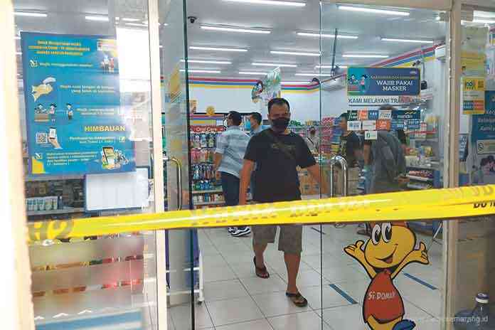 DIBOBOL : Anggota Polres Magelang melakukan olah TKP di Indomaret, Jalan Sarwo Edi Wibowo, Banyurojo, Mertoyudan, Magelang, Jumat (13/8) pagi. (LUQMAN SULISTIYAWAN/JAWA POS RADAR MAGELANG)
