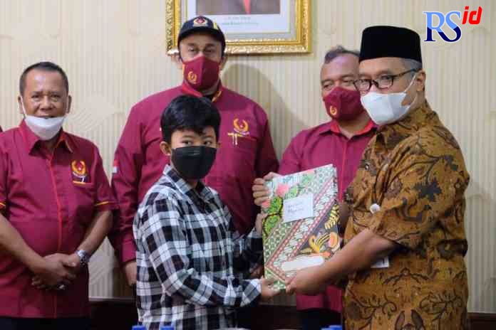 BERI PERHATIAN : Wali Kota Magelang dr Muchamad Nur Aziz menyampaikan bonus dari dewan penyantun KONI Kota Magelang kepada atlet selam berprestasi Aulia Zahra Wahyudia Pratiwi Kamis, (13/1), di ruang rapat Wali Kota Magelang. (PEMKOT MAGELANG for jawa pos