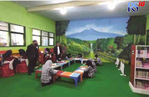 TINGKATKAN LITERASI: Kepala Sekolah SMPN 1 Tengaran berfoto di ruang perpustakaan digital SMPN 1 Tengaran. (NURFAIK NABHAN/Jawa Pos Radar Semarang)