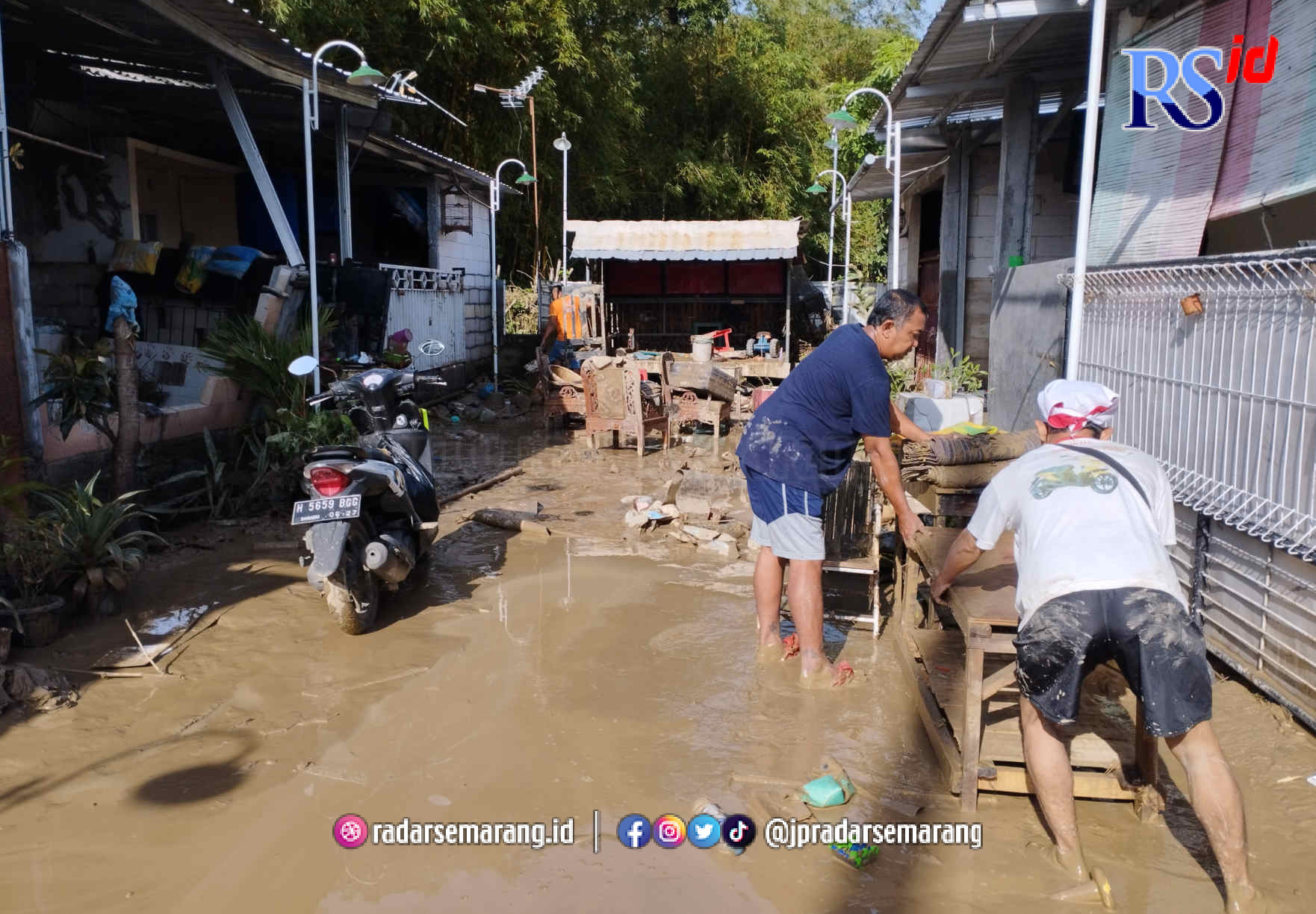 Warga Perum Arion Mas 6 sedang membersihkan rumah dari sampah dan lumpur sisa banjir Sabtu (7/1/2023) pagi. (Pratono/Jawa Pos Radar Semarang)