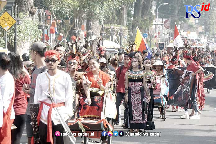 Sejumlah mahasiswa UKSW tampak mengenakan pakaian adat nusantara dan membawa miniatur rumah adat. (Dhinar Sasongko/Jawa Pos Radar Semarang)