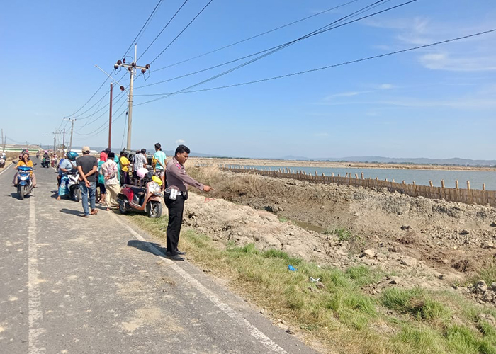 MENEWASKAN KORBAN: Polisi melakukan olah TKP laka tunggal di jalan raya Desa Marengan.&nbsp;