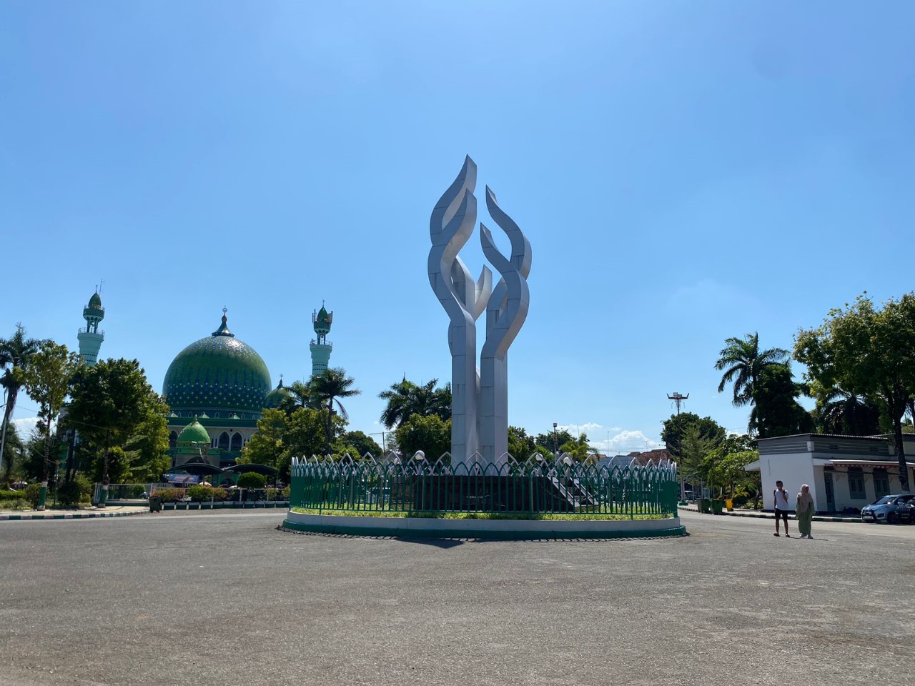 IKONIK: Pengunjung taman Arek Lancor melewati tugu ikonik, Minggu (3/9). (MOH. JUNAIDI/JPRM)