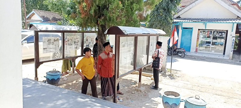 CINTA BACA: Santri membaca koran Jawa Pos dan Jawa Pos Radar Madura yang dipajang di Pondok Pesantren Annuqayah Daerah Latee, Minggu (30/7). (LUKMAN HAKIM AG./JPRM)