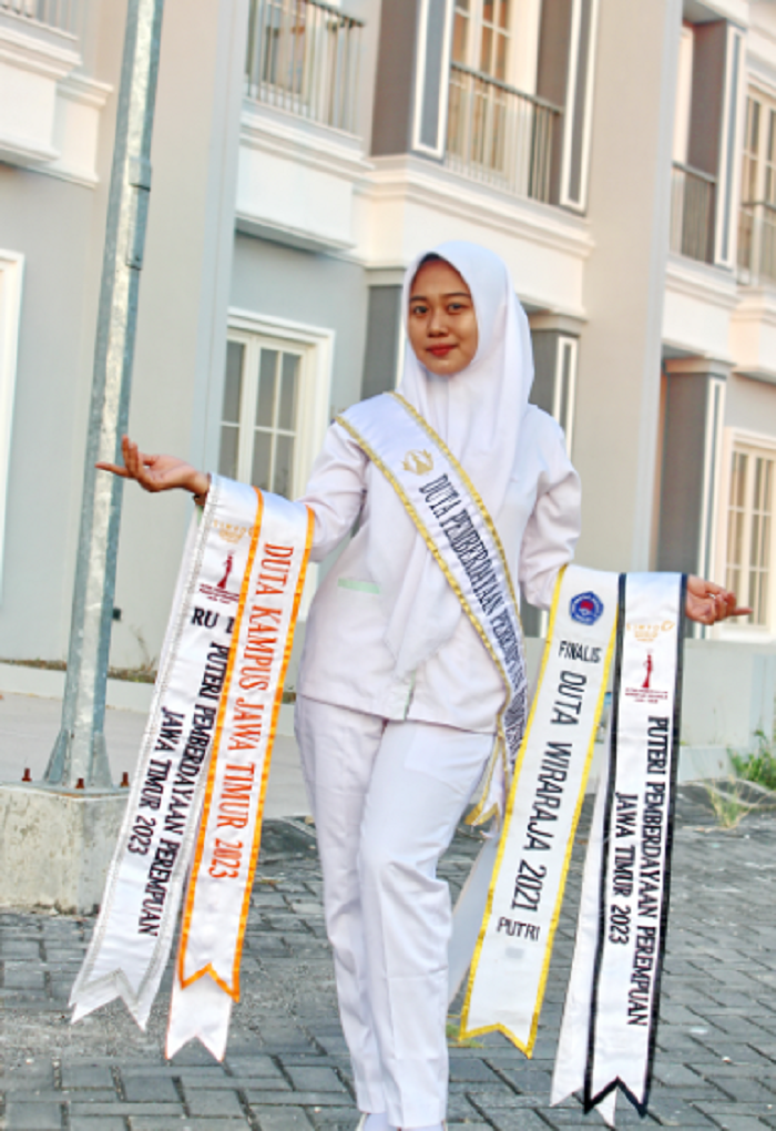 BUKTI PRESTASI: Puteri Pemberdayaan Perempuan Indonesia Arita Aprilicyana menunjukkan selempang penghargaan yang diperoleh selama berkarier, Rabu (18/10). (MOH. BUSRI/JPRM)