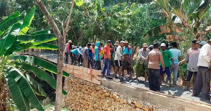 SWADAYA: Warga Dusun Galis dan warga Dusun Karang Dalem, Desa Pakamban Laok, Kecamatan Pragaan, bergotong royong memperbaiki jembatan Selasa (7/11).