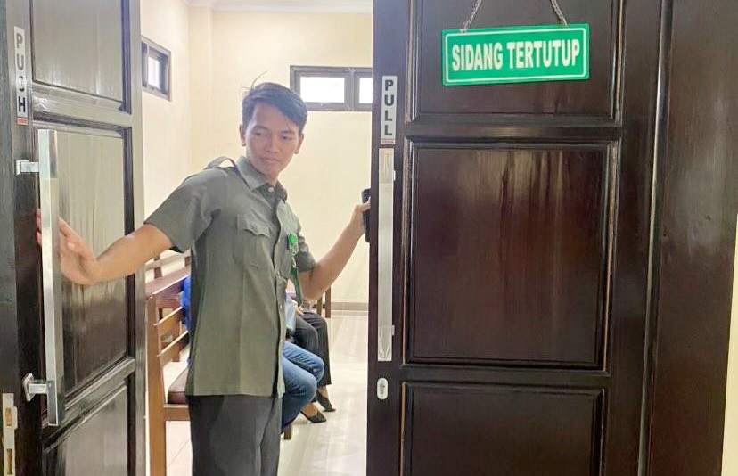 TERTUTUP: Petugas menutup pintu ruang sidang di PN Sampang, Selasa (14/11). (MOH. IQBAL AFGANI/JPRM)